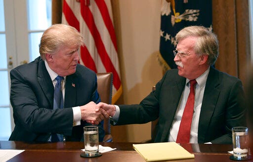 FILE - In this April 9, 2018 file photo, President Donald Trump, left, shakes hands with national security adviser John Bolton in the Cabinet Room of the White House in Washington at the start of a meeting with military leaders. Trump has fired national security adviser John Bolton. Trump tweeted Tuesday that he told Bolton Monday night that his services were no longer needed at the White House. (AP Photo/Susan Walsh)