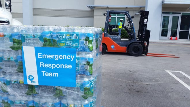 Bottles of water bound for the Bahamas are part of millions of dollars in donations flowing from Florida. [JEFF OSTROWSKI/palmbeachpost.com]