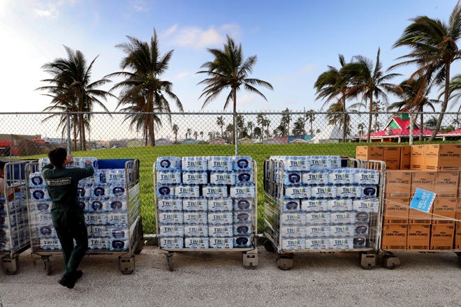 Bottled water is offloaded from the Royal Caribbean's Mariner of the Seas cruise ship after arriving in Freeport, Bahamas, Saturday, Sept. 7, 2019. The ship delivered thousands of meals and cases of bottled water to Freeport early Saturday morning. (Joe Burbank /Orlando Sentinel via AP)