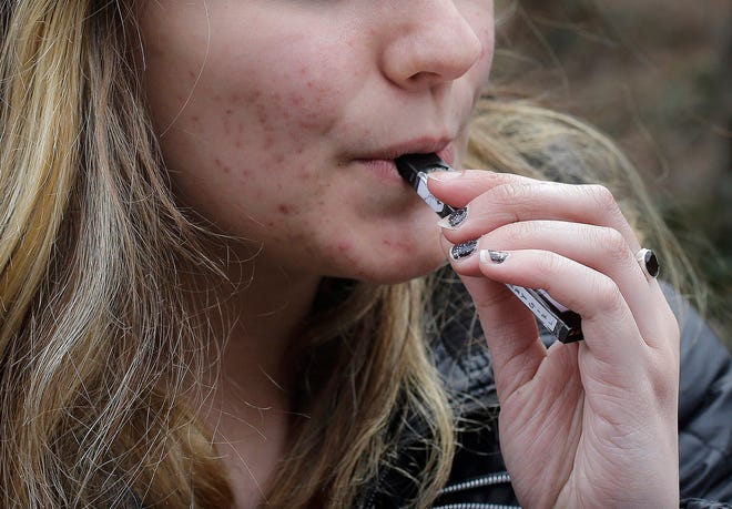 Health and education officials across the country are raising alarms over wide underage use of e-cigarettes and other vaping products. The devices heat liquid into an inhalable vapor that's sold in sugary flavors like mango and mint — and often with the addictive drug nicotine. [AP FILE PHOTO]