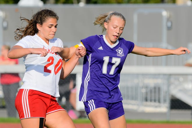 Little Falls Mountie Gabby Sylstra (17) moves the ball against Sauquoit Valley Indian Alexa Sheppard (20) during Wednesday's match in Little Falls, New York. 

[Alex Cooper / Observer-Dispatch]