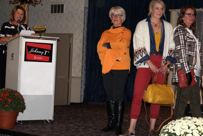 Patti Bailey describes fashions worn by Jan Brodbeck, Stephanie Gordon and Kelly Lantis. [NANCY HASTINGS PHOTO]