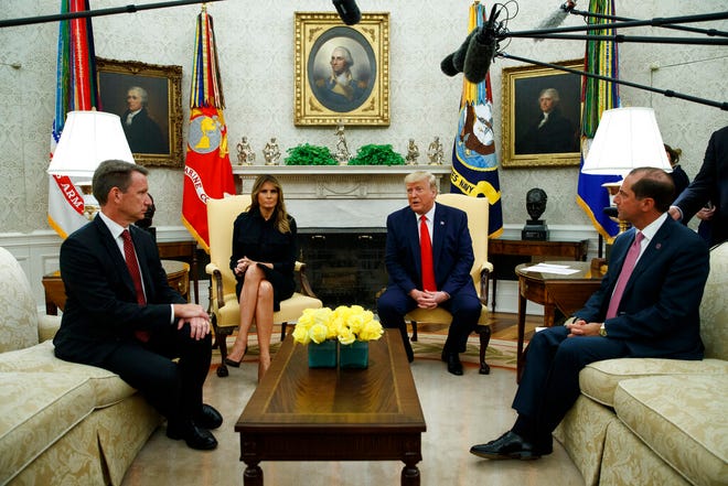 President Donald Trump talks about a plan to ban most flavored e-cigarettes, in the Oval Office of the White House, Wednesday, Sept. 11, 2019, in Washington. From left, acting FDA Commissioner Ned Sharpless, first lady Melania Trump, Trump, and Secretary of Health and Human Services Alex Azar. (AP Photo/Evan Vucci)