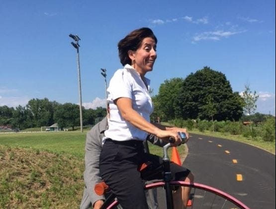 Gov. Gina Raimondo tries out the newest section of the Blackstone River Bikeway on Thursday. [M. Charles Bakst photo / Special to The Journal]