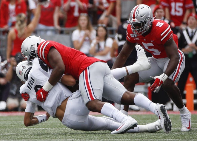 Ohio State Buckeyes defensive end Tyreke Smith (11) sacks Cincinnati Bearcats quarterback Desmond Ridder (9) during the first quarter of a NCAA Division I football game between the Ohio State Buckeyes and the Cincinnati Bearcats on Saturday, September 7, 2019 at Ohio Stadium in Columbus, Ohio. [Joshua A. Bickel/Dispatch]