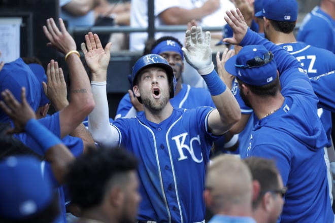 Kansas City Royals' Hunter Dozier celebrates in the dugout after his three-run home run off Chicago White Sox starting pitcher Lucas Giolito during the sixth inning of a baseball game Thursday in Chicago. [Charles Rex Arbogast/The Associated Press]