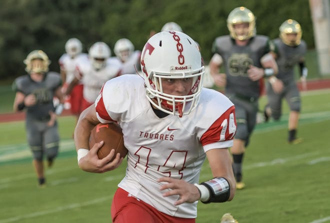 Tavares' Stephen Cyr (14) breaks off a run against The Villages on Aug. 29 in The Villages. [PAUL RYAN / CORRESPONDENT]