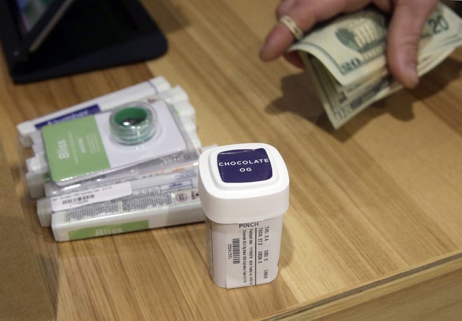 A customer purchases recreational marijuana at a dispensary in Leicester, Mass. Alternative Therapies Group's new location in Salisbury, Mass., offers a location near southeastern New Hampshire. [AP photo/Steven Senne, file]