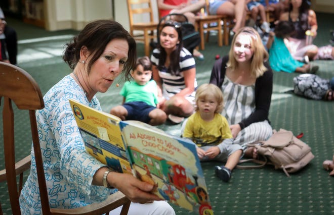Head librarian Susan Harris reads All Aboard to Work -- Choo Choo! during the first day of Summer Story Time June 4, 2019 at the Society of the Four Arts' children's library. Story Time will take place on select Tuesdays, Wednesdays and Thursdays in June and July at 10:30 a.m. The sessions will be based on educational themes and include songs, rhymes, and crafts for children 8 and under. [Damon Higgins/palmbeachdailynews.com]