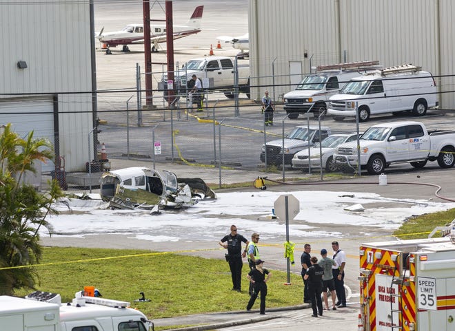 A small single-engine plane sits crashed in a parking lot at Boca Raton Airport on Wednesday, September 11, 2019. Two people were injured, authorities said. One person was taken to a hospital as a trauma alert, and the other was treated at the airport. [LANNIS WATERS/palmbeachpost.com]