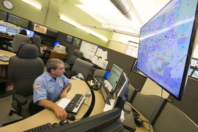 Dave Spataro, a Rockford 911 telecommunicator, studies an electronic city map featuring real-time locations for on-duty fire, police and ambulance crews on June 8, 2017. [ARTURO FERNANDEZ/RRSTAR.COM STAFF]