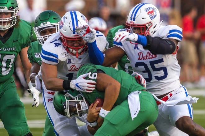 SMU linebacker Richard Moore, left, and defensive end Delontae Scott sack North Texas quarterback Mason Fine last weekend. "They are very multiple in all three phases of the ball — offense, defense and special teams," Texas State coach Jake Spavital says of the Mustangs. [SMILEY N. POOL/THE DALLAS MORNING NEWS]