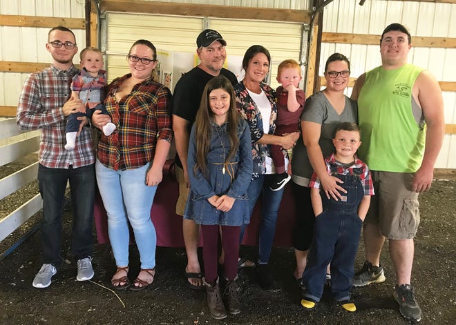 This year’s photo contest winners are (from left) Liam Gillette, held by parents Boston Gillette and Ashley Oliver; Cam Yocum, held by parents Zac and Courtney Yocum with sister Lyric Porter; and Gavin Hughes, with parents Katlyn Ault and Trey Hughes. [Hannah Schrodt/Daily Ledger]