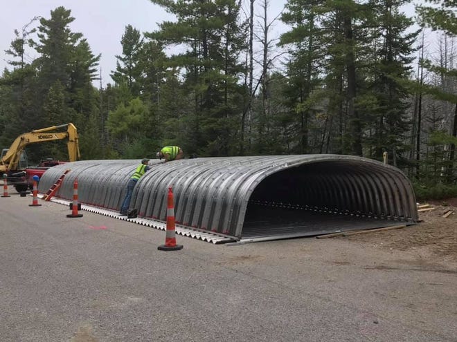 Jake Brandau and Steve Sanford of the Cheboygan County Road Commission are working dilligently to make sure the large culvert that will be placed on Seffern Road is put together securely and correctly, so the structure will be able to stay in place for many years. Photo by Travis Horrocks