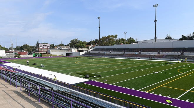 Work continues on the new turf field at Erie Veterans Memorial Stadium in Erie, shown here on Friday. The final details of the new field, including end zone and mid-field logos, might not be done for two more weeks. [CHRISTOPHER MILLETTE/ERIE TIMES-NEWS]
