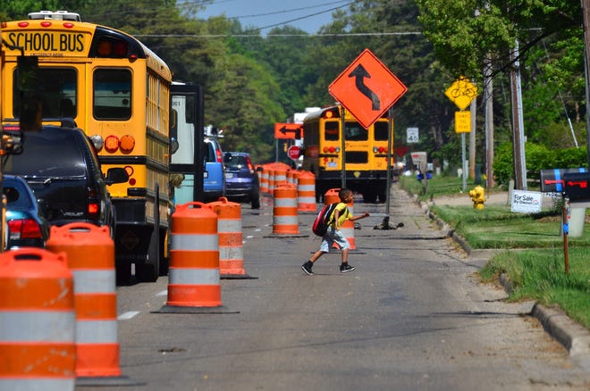 In this 2014 file photo, road construction takes place on Ottawa Beach Road. Road funding is one the largest issues preventing the state's legislature from producing a budget ahead of the end of the fiscal year. (Sentinel File)