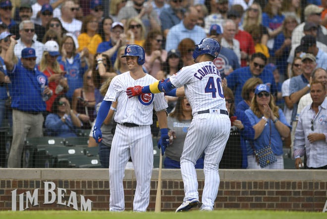 Chicago Cubs' Willson Contreras (40) celebrates with teammate Nico Hoerner left, after hitting a solo home run during the first inning of a baseball game against the Pittsburgh Pirates, Friday, Sept. 13, 2019, in Chicago. (AP Photo/Paul Beaty)