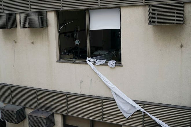 A rope made of bedsheets was used to escape late Thursday from the upper floor of the Badim Hospital, where a fire left at least 11 people dead, in Rio de Janeiro, Brazil. The fire raced through the hospital forcing staff to wheel patients into the streets on beds or in wheelchairs.
