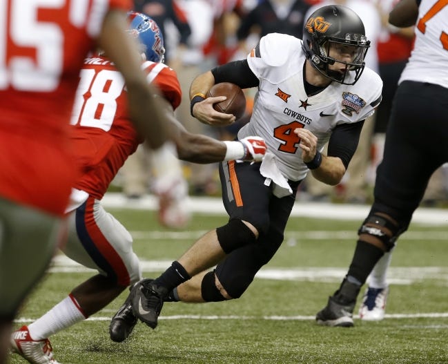 Oklahoma State's J.W. Walsh (4) scrambles during the Allstate Sugar Bowl against the Ole Miss Rebels at the Mercedes-Benz Superdome in New Orleans on Jan. 1, 2016. [Bryan Terry/The Oklahoman]