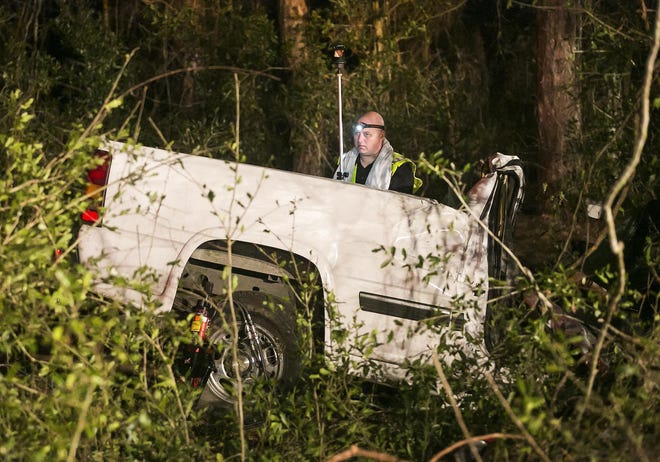 Florida Highway Patrol Cpl. Jason Roberts takes measurements at the scene of a fatal accident in February 2018. The accident occurred across from the Electra Cemetery on 314A. [Doug Engle/Star-Banner/File]