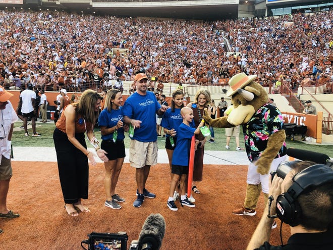 During the University of Texas-Louisiana State football game Sept. 7, St. David's HealthCare granted the wish of Make-A-Wish recipient Steel, who is suffering from a rare form of bone cancer. Steel, 9, was granted a beach vacation of his dreams. Last year, doctors discovered Steel had Ewing's sarcoma, which caused a tumor to grow on his skull. His treatment included nine months of chemotherapy and 30 rounds of radiation. Pictured, from left to right, are Denise Bradley, vice president for communication & community affairs for St. David's Healthcare, Steel's mother, Steel's father, Steel's sister, Steel and Kathrin Brewer, president and CEO of Make-A-Wish Central & South Texas. [Photo courtesy St. David's HealthCare]