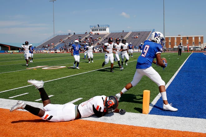 Millwood's Michael Taffe runs past Corian Howard of Douglass to score a touchdown during the annual Soul Bowl football game between Millwood and Douglass at Langston, Saturday, Sept. 14, 2019. [Bryan Terry/The Oklahoman]
