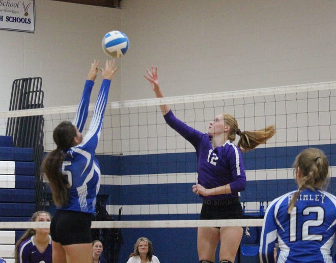 Pickford's Darcy Bennin (12) tries to hit past the blocking of Brimley's Victoria Aikens (5) during an EUPC volleyball match Thursday. [Scott Church/For The Sault News]