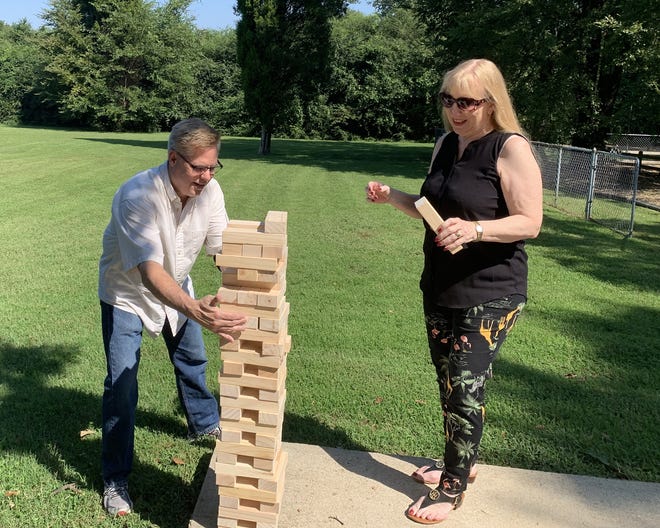 Father Michael Briggs, left, and Lucy Hill are seen with a giant Jenga game, which will be one of the many features at the third annual Community Celebration event. The free, all-ages gathering will begin at 10:30 a.m. Sept. 22 at St. Bartholomew's Episcopal Church, 2701 Old Greenwood Road. The event will include food, live music, vendors, games for chidren and adults, Irma Purcell's Beautiful Bags project, an outdoor church service, a photo booth and more. [PHOTO COURTESY OF BECKY IBISON]