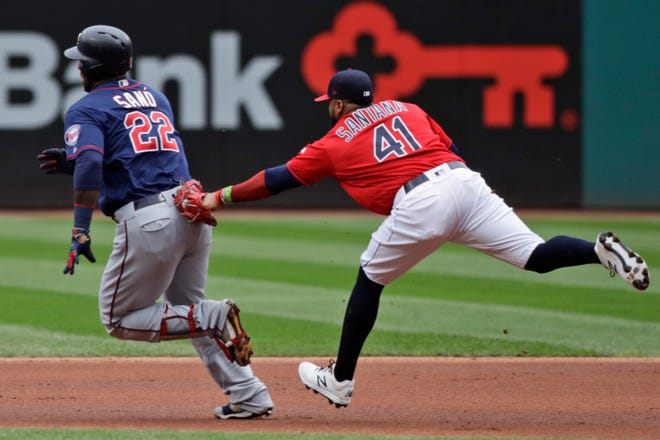 Cleveland Indians' Carlos Santana (41) tags out Minnesota Twins' Miguel Sano (22) in the first inning in a baseball game, Sunday, Sept. 15, 2019, in Cleveland. [TONY DEJAK/THE ASSOCIATED PRESS]