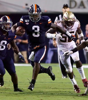 Virginia quarterback Bryce Perkins (3) runs the ball past Florida State linebacker Emmett Rice (56) during the first half of an NCAA college football game in Charlottesville, Va., Saturday, Sept. 14, 2019. (AP Photo/Andrew Shurtleff)
