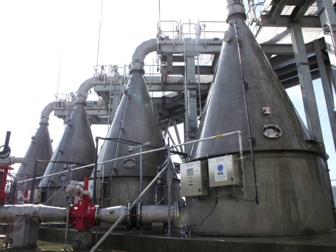 FILE - In this Feb. 21, 2019 file photo, four cone-shaped machines designed to mix oxygen into river water and inject it back into the Savannah River stand on the shore of the waterway in Savannah, Ga. Conservation groups say they þÄúremain skepticalþÄù that machines injecting oxygen into the Savannah harbor will offset threats to fish caused by deepening the busy shipping channel. However, the Southern Environmental Law Center says the groups it represents wonþÄôt return to court to fight the $973 million expansion of the waterway to the Port of Savannah. (AP Photo/Russ Bynum, File)