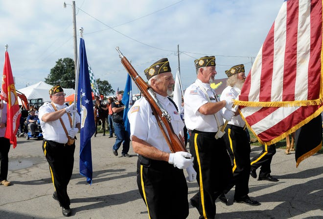 The Color Guard leads the Walk of Honor to the Cheyenne Spidel Memorial Pavilion as part of Veterans Day at the Ashland County Fair on Monday.