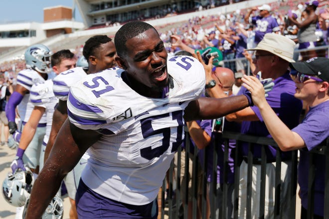 Kansas State defensive end Reggie Walker (51) celebrates with fans following their NCAA college football game win, 31-24, over Mississippi State in Starkville, Miss., Saturday, Sept. 14, 2019. (AP Photo/Rogelio V. Solis)