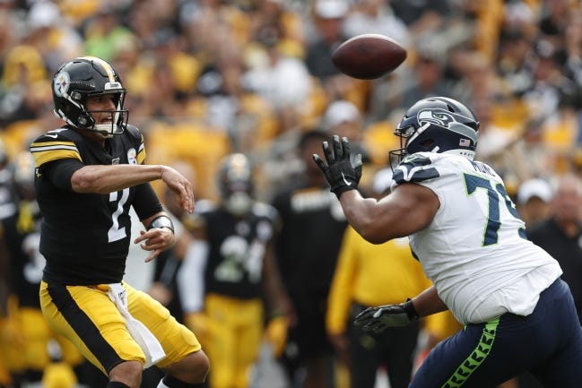 Pittsburgh Steelers quarterback Mason Rudolph, a former Oklahoma State standout, passes over Seattle Seahawks nose tackle Bryan Mone in the second half of an NFL football game Sunday, Sept. 15, 2019, in Pittsburgh. (AP Photo/Don Wright)