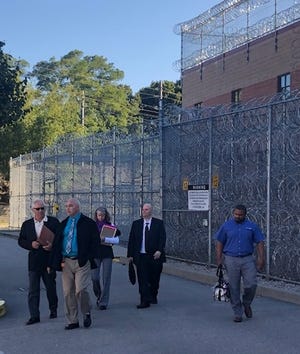 Donald W. Wyatt Detention Facility Warden Daniel Martin leads a group away from the prison and to the location of Monday's closed meeting of the prison's board of directors. [The Providence Journal / Kevin G. Andrade]