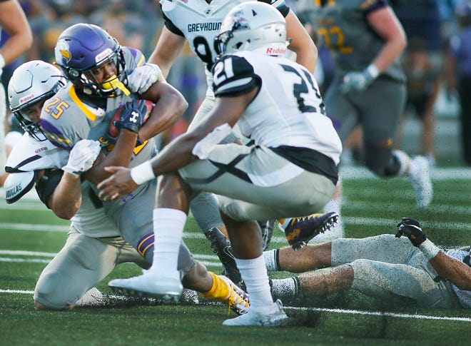Ashland University’s Gei'vonni Washington (25) is brought down by Indianapolis’ Joe Lambright (28) during a college football game earlier this season. The Eagles host No. 2-ranked Ferris State Saturday at 7 p.m.