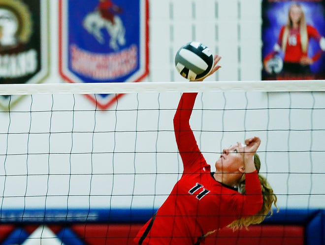 Crestview's Autumn Bailey (11) spikes the ball against Mapleton during a high school volleyball game. The Cougars won in straight sets.