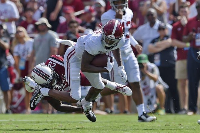 Alabama's DeVonta Smith, top, rushes while defended by South Carolina's J.T. Ibe during the first half of an NCAA college football game Saturday in Columbia, S.C. [Richard Shiro/Associated Press]
