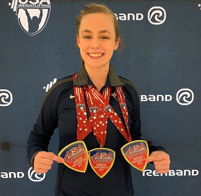 Iron Jungle weightlifter Taylor Woods poses with the three gold medals she won over the weekend at USA Weightlifting’s American Open 3 in Daytona Beach. [SUBMITTED]