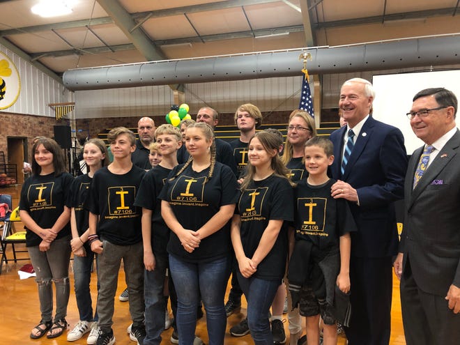 Mulberry Mayor Gary Baxter, right, and Gov. Asa Hutchinson, second from right, pose for a photo with the Mulberry robotics class on Monday, Sept. 16, 2019. Hutchinson ended his fall 2019 computer science tour at an assembly with students from the school district. [JADYN WATSON-FISHER/TIMES RECORD]