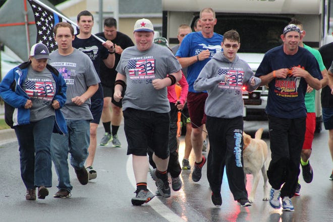 Several athletes from Special Olympics of Michigan joined in on the Law Enforcement Torch Run through downtown Cheboygan on Sept. 11, as the runners made their way from the north end of Cheboygan to the Cheboygan County Building. Photo by Kortny Hahn