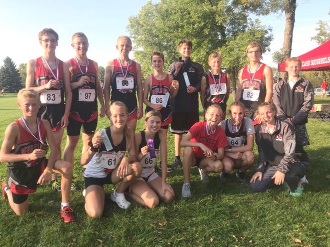 The boys and girls Devils Lake cross country team posing with their medals after winning the Central Cass Cross Country meet on Tuesday, Sept. 17, 2019 in Casselton.