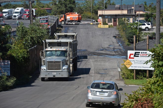 Trucks leave the Erie Coke Corp. plant main entrance at the foot of East Avenue in Erie on Wednesday. The State Department of Environmental Protection released results of air-quality samples that found concentrations of benzene, a known carcinogen, that exceeded an "action level" set by the department but does not present an "immediate risk to the community," the DEP announced. [CHRISTOPHER MILLETTE/ERIE TIMES-NEWS]