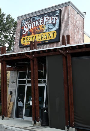 The Smoke Pit, a restaurant chain with three other locations in the Charlotte region, will open in October in the former home of Tavern 24 in Gastonia. [JOHN CLARK/THE GASTON GAZETTE]