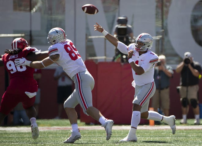 Ohio State Buckeyes quarterback Justin Fields (1) gets a block from tight end Luke Farrell (89) on Indiana Hoosiers defensive lineman Jerome Johnson (98) as he throws a pass during the first quarter of the NCAA football game at Memorial Stadium in Bloomington, Ind. on Saturday, Sept. 14, 2019. [Adam Cairns/Dispatch]
