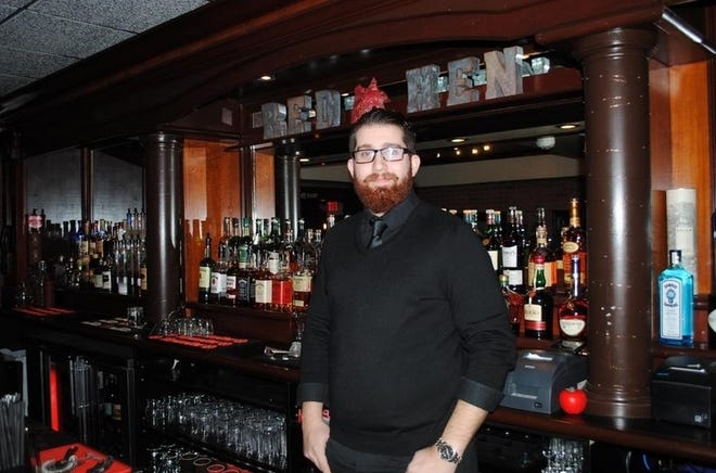 Alex Collazo stands behind the bar at The Red Hen's former location on Anawan Street in 2018. [Herald News File Photo]