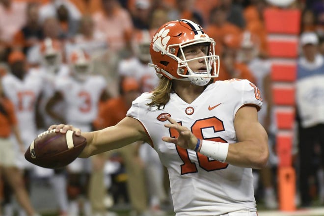 Clemson quarterback Trevor Lawrence throws a touchdown pass against Syracuse during the first half Saturday in Syracuse, N.Y. [STEVE JACOBS/THE ASSOCIATED PRESS]
