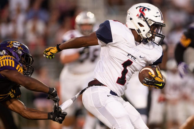 Terry Sanford's Israel Reuben outruns the grasp of Jack Britt's Tyquan Patterson during the Bulldogs' 21-10 loss on Aug. 30. Terry Sanford is averaging 213 rushing yards per game. [Andrew Craft/The Fayetteville Observer File Photo]