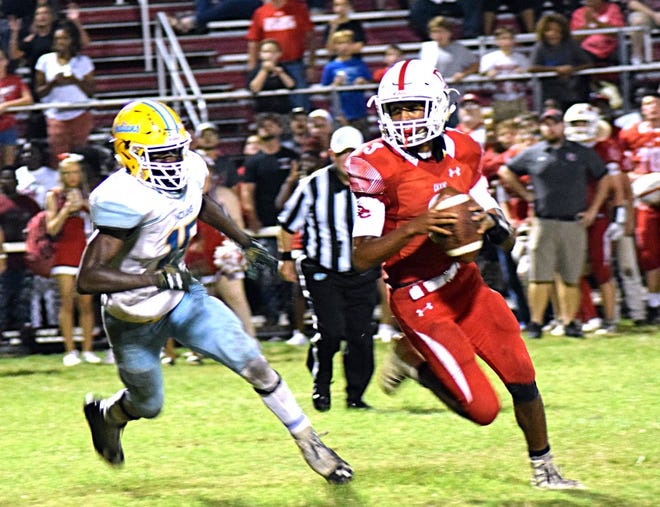 Dixie County quarterback Sam Cannon gets pressured during last year's regular-season game won by Chiefland, 27-20. [Larry Savage/Staff]