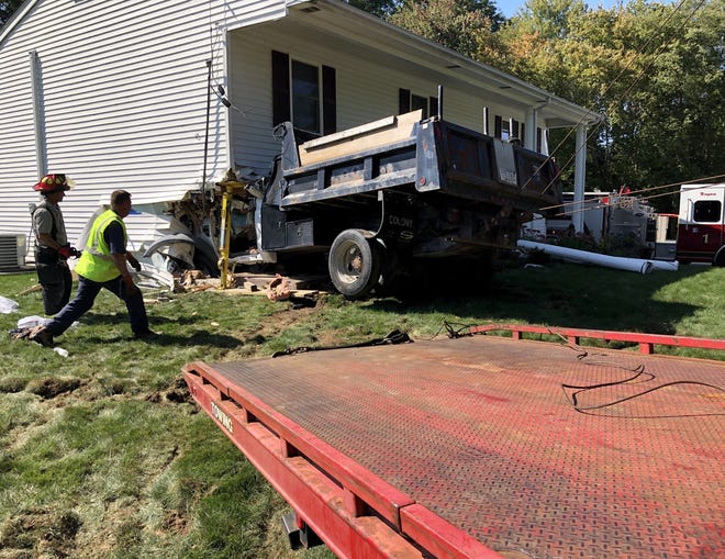 A dump truck drove into the corner of a house at 170 Norton Ave. in Taunton Thursday afternoon, Sept. 19, 2019 injuring the driver who was transported to Rhode Island Hospital.

Taunton Gazette photo by Charles Winokoor